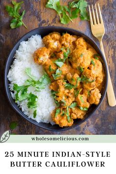 a bowl filled with white rice and chicken curry next to a fork on top of it