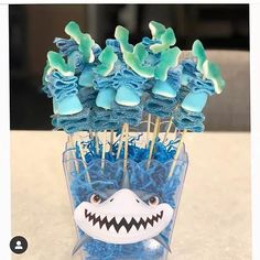 toothpicks with blue and green decorations in a cup