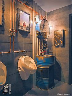 two urinals and a sink in a bathroom