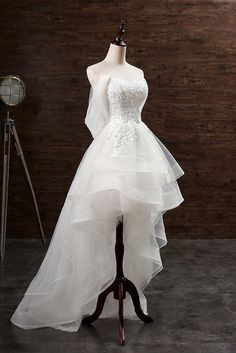 a white wedding dress on a mannequin