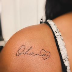 the back of a woman's shoulder with a tattoo on it that says, ohana