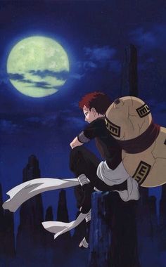 a man sitting on top of a rock in front of a full moon