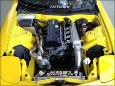 the engine compartment of a yellow sports car