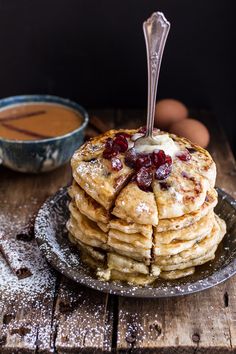 a stack of pancakes with butter and jelly on top