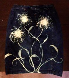 a black skirt with white flowers painted on it