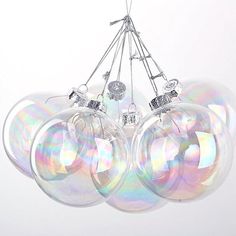 a bunch of shiny glass ornaments hanging from a ceiling