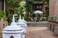 an outdoor patio area with tables and chairs