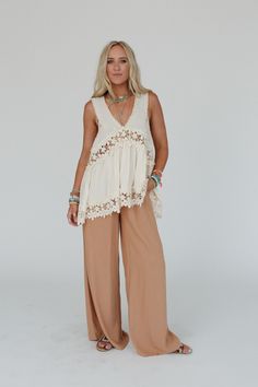 Fun, flowy, and unique—every boho gal's dream! The Catania Lace Trim Tunic Top is exactly what you've been looking for. Don't miss out! So pretty, intricate crochet fabric and contrast details throughout Relaxed and loose tank top silhouette Classic V - neckline and sleeveless design with thick tank straps Low V - backline with classic zipper back closure for comfortable fit Slight high - low crochet trim bottom edge with a rounded back edge for added boho style Pair with: Evermore Seamless Lace Bohemian V-neck Lace Top For Vacation, Lace Top With Crochet Trim For Vacation, Vacation Lace Trim V-neck Top, Flowy Lace Tops For Vacation, V-neck Lace Top With Lace Trim For Vacation, Summer Vacation Crochet Top With Lace Patchwork, Bohemian Lace Top With Lace Trim For Vacation, Beach Beige Lace Top With Lace Trim, Bohemian V-neck Top With Lace Patchwork