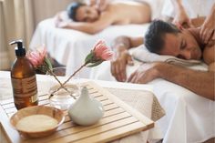 a man and woman laying down in a spa