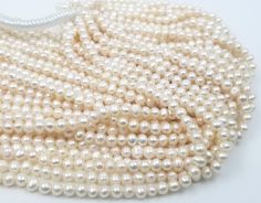 white pearls are arranged on a white surface