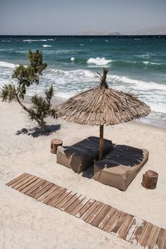 an umbrella and lounge chairs on the beach