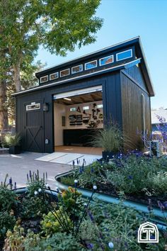 a black garage with lots of plants and trees