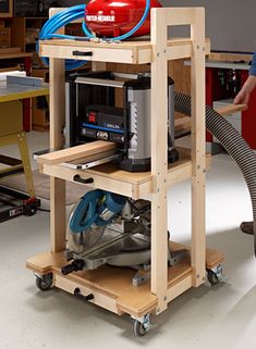 a person standing next to a workbench in a room with tools on it