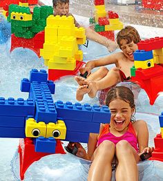 several children are playing in the water at an amusement park with legos on it