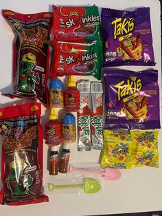 various snacks and condiments are laid out on a counter top, including chips