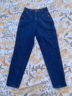 Bonjour Vintage High Waisted Blue Jeans Vintage dark blue high waisted femme fit jeans with 2 front and 2 back pockets  Size: 9/10 Measures: 27" waist 30" leg 12" rise 22" hips-flat (B8) Classic High Waist Blue Jeans, High Rise Blue Jeans With Belt Loops, Dark Wash High Waist Jeans With Belt Loops, Retro High Waist Dark Wash Jeans, Vintage Dark Wash Tapered Leg Jeans, Vintage Tapered Leg Dark Wash Jeans, Blue High-waisted Jeans With Belt Loops, Vintage High Rise Dark Wash Bottoms, Womens Jeans