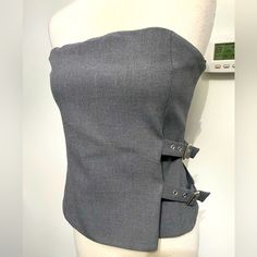 Zara Gray Strapless Top Wit Buckle Detail. Top Has A Hidden Side Zipper With A Straight Neckline And Fully Lined. Please Note: Top Is Actually A Size Xl, But Because Tops Like This From Zara Run Small, I Am Listing It As A Size L. Made Of: 63% Polyester/32% Nylon/5% Elastane Zara Strapless Top, Elegant Fitted Bandeau Tank Top, Chic Strapless Tops By Zara, Elegant Sleeveless Zara Tube Top, Elegant Bandeau Tops By Zara, Elegant Zara Sleeveless Tube Top, Chic Fitted Gray Crop Top, Fitted Strapless Tube Top By Zara, Elegant Sleeveless Zara Crop Top