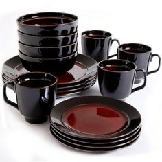 a set of black and brown dinnerware on a white background with red rims