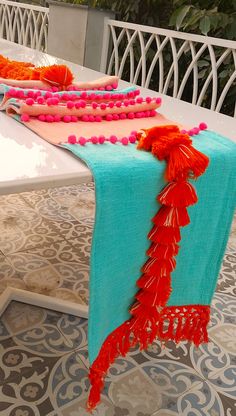 the table is decorated with bright colors and tassels