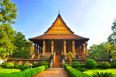 a gazebo surrounded by lush green trees and bushes