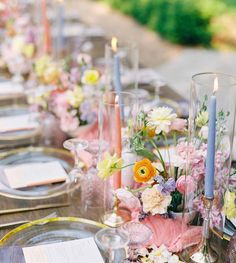 the table is set with flowers and candles