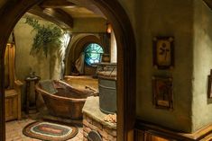 a bath tub sitting inside of a bathroom on top of a floor next to a doorway