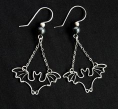 "Spookily cute bat earrings are handcrafted from silver filled wire, carefully wrapped into the shape of your favorite flying mammal! Metal has been antiqued then polished, for a lovely contrasting finish. \"Bats\" measure approximately 1.25 inches from wingtip to wingtip, and hang from comfortable French hook ear wires. Total earring length from top of ear wire to bottom of bat dangle is approximately 2.25 inches. *Silver filled wire meets the same legal requirement of \"gold filled\" as it is Bat Wire Wrap, Earing Inspiration, Rings Video, Bead Bugs, Halloween Jewelry Diy, Wire Shapes, Wounded Healer, Bat Jewelry, Kitchen Witchery