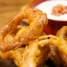 fried onion rings with ranch dip on the side