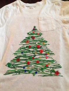 a white shirt with a christmas tree on it