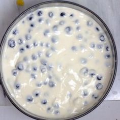 a bowl filled with blueberries sitting on top of a table