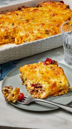 a piece of casserole on a plate with a fork next to the casserole