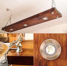 a light fixture hanging from the ceiling above a wooden table with metal chains on it