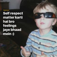 a young boy wearing sunglasses and giving the thumbs up sign with his hand in front of him