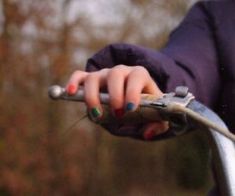 a close up of a person's hand on a handlebar