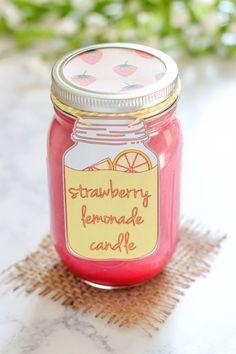 a jar filled with strawberry lemonade candle sitting on top of a table