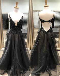 Black Sleeveless Ball Gown For Party, Sleeveless Black Ball Gown For Party, Black Ball Gown With Fitted Bodice For Party, Black V-neck Gown With Sweep Train, Black Low Back Gala Dress, Backless Prom Gown With Sheer Bodice, Black Evening Dress With Corset Back For Prom, Backless Sheer Bodice Prom Gown, Black Tulle Gown With Corset Back