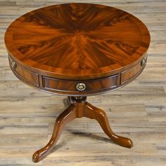 a round wooden table with two drawers on each side