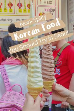 an ice cream cone is being held up by two people in front of a sign that says, non - spicy korean food you should try