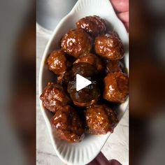 a white bowl filled with meatballs on top of a table