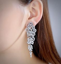 A beautiful pair of bridal earrings that is sure to make a bold statement on your Wedding Day! Adorned with glowing cubic zirconia that capture the light from every angle with a perfectly translucent appeal, the earrings are rhodium/rose gold plated for a bright finish which enhances the intricate detailing and conveys a modern take on old elegance. Length of the earring is 2.4" (approx. 6.1cm); Width: 0.7" (approx. 1.8cm); Weight: 12g. Available in Silver and Rose Gold finishes. To make your ch Wedding Earrings Silver, Cubic Zirconia Bridal Earrings, Silver Earrings Wedding, Rhinestone Bridal, Matching Bracelets, Modern Bride, Wedding Earrings, Earrings Silver, Bridal Earrings