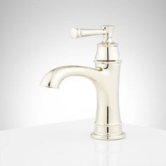 a white sink faucet sitting on top of a counter