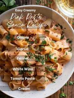 a white bowl filled with pasta and garnished with parsley