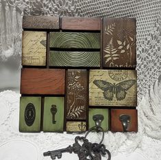 a bunch of wooden blocks sitting on top of a white lace covered table next to a key