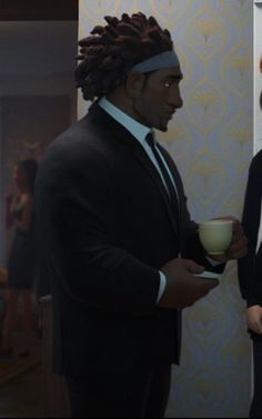 two people in suits and ties are standing together, one is holding a coffee cup