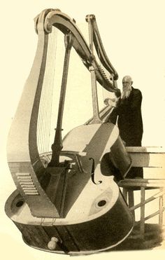 a man standing next to a giant harp