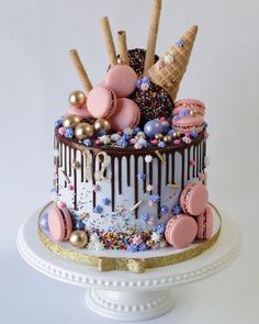 a decorated cake with ice cream, sprinkles, and chocolate icing