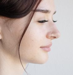 a close up of a woman's face wearing earrings