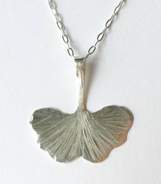 "Hand forged Sterling silver or brass etched and engraved Artisan Gingko leaf necklace measuring 1\"x1\" suspended on a sterling silver or gold filled chain." Unique Etched Sterling Silver Necklace, Silver Etched Nature-inspired Necklaces, Nature-inspired Silver Etched Necklaces, Nature-inspired Sterling Silver Etched Jewelry, Nature-inspired Etched Sterling Silver Jewelry, Etched Silver Nature-inspired Jewelry, Etched Nature-inspired Silver Jewelry, Nature-inspired Etched Silver Jewelry, Nature-inspired Engraved Sterling Silver Necklace