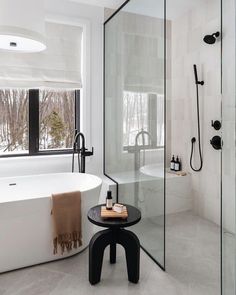 a white bath tub sitting next to a walk in shower