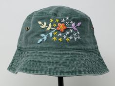 Item: flower embroidered bucket hat Material: 100% cotton Size: one size fits most Embroidery: hand made with acrylic thread Free first class shipping, upgradable priority mail service. 30 days return policy, feel confident at your purchase! Cotton Bucket Hat With Curved Brim For Festivals, Casual Summer Hats With Custom Embroidery, Bohemian Cotton Bucket Hat For Spring, Casual Embroidered Sun Hat With Curved Brim, Summer Cotton Embroidered Hats, Casual Cotton Sun Hat With Embroidery, Cotton 5-panel Hat For Spring, Custom Embroidered Cotton Hats For Summer, Handmade Cotton Sun Hat Cap